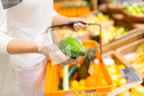 Image of close up of woman with food basket in market