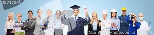 Image of happy bachelor with diploma over professionals