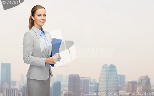 Image of smiling businesswoman holding folder