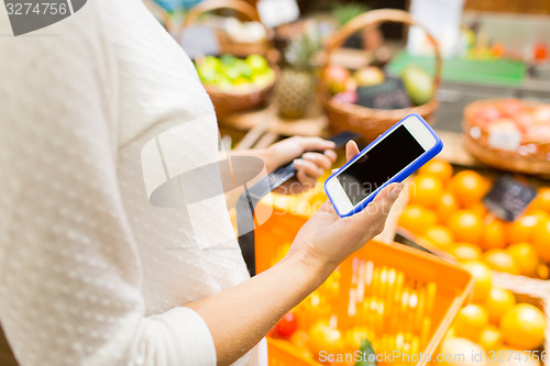 Image of close up of woman with food basket in market