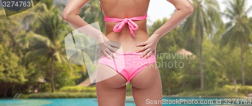 Image of close up of young woman buttocks in pink bikini