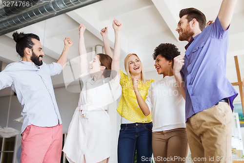 Image of happy creative team in office