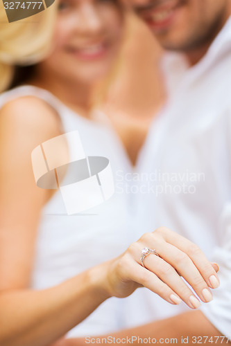 Image of romantic man proposing to beautiful woman