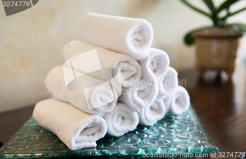 Image of rolled bath towels at hotel spa