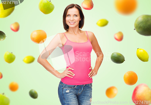 Image of woman in blank pink tank top over fruits on green