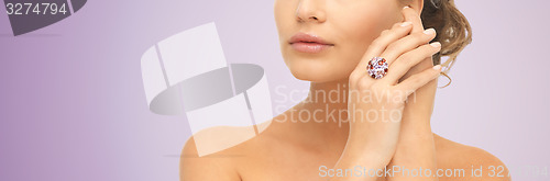 Image of close up of woman with cocktail ring on hand