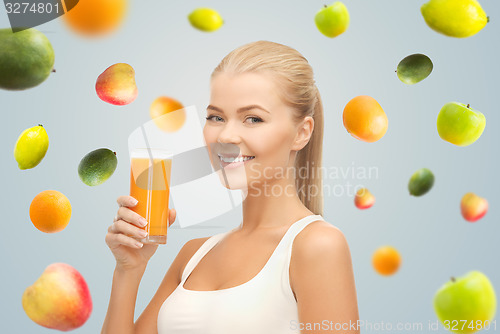 Image of happy woman holding glass of orange juice