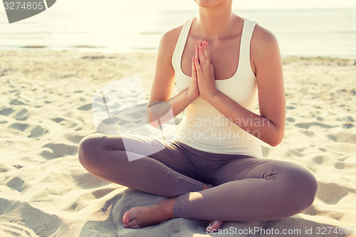 Image of close up of woman making yoga exercises outdoors