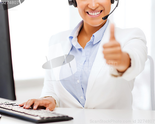 Image of african female helpline operator showing thumbs up