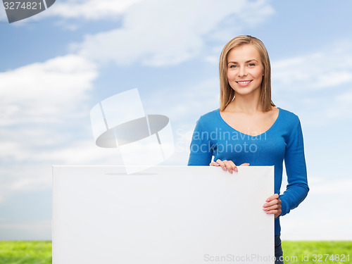 Image of smiling young woman with blank white board