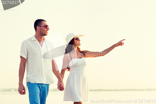 Image of smiling couple walking outdoors