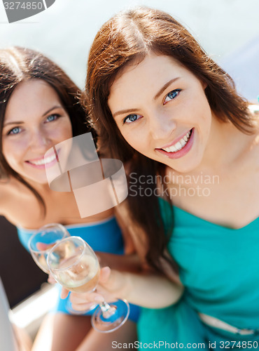 Image of girls with champagne glasses on boat