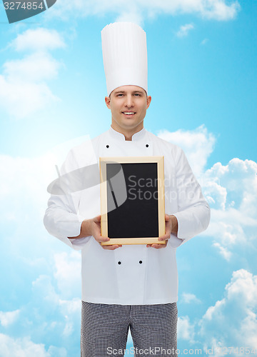 Image of happy male chef cook holding blank menu board