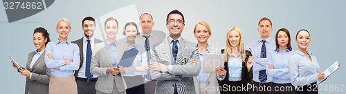 Image of group of happy businesspeople over blue background