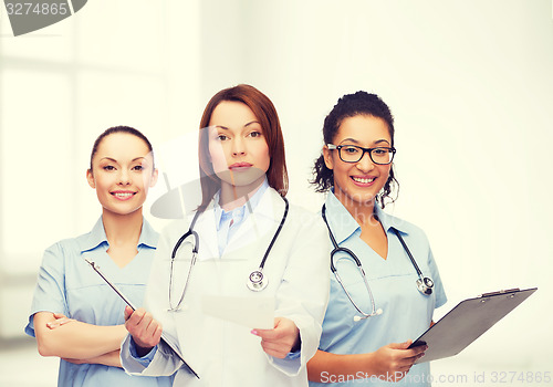 Image of calm female doctor with clipboard