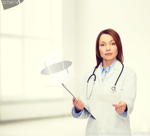 Image of calm female doctor with clipboard