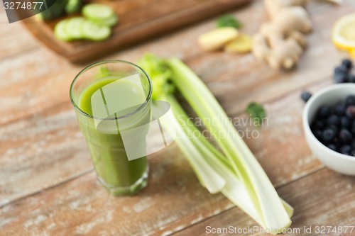 Image of close up of fresh green juice glass and celery