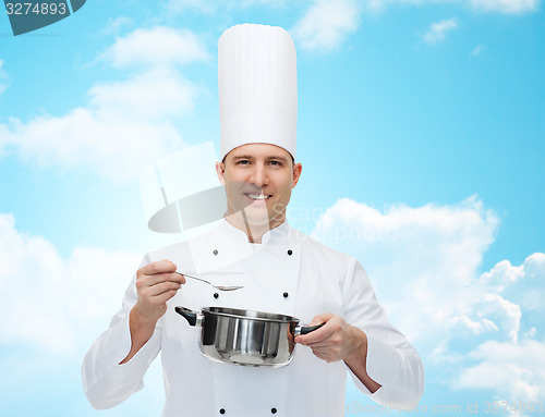 Image of happy male chef cook with pot and spoon