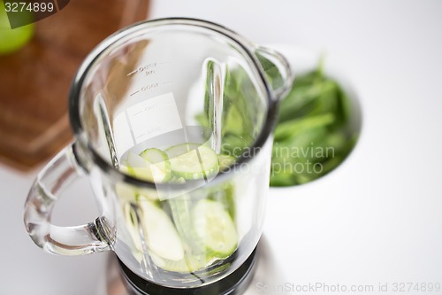 Image of close up of blender jar and green vegetables