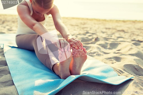 Image of close up of woman making yoga exercises outdoors