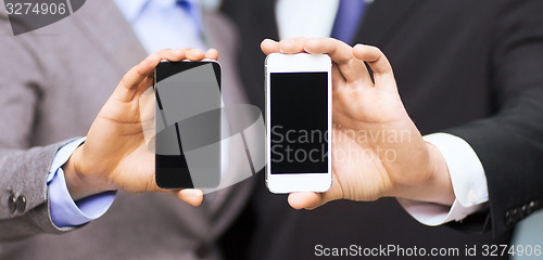 Image of businessman and businesswoman with smartphones