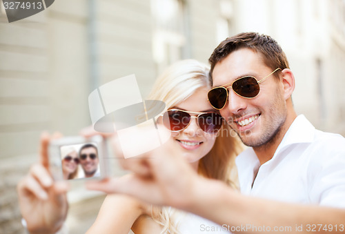 Image of couple taking photo in cafe