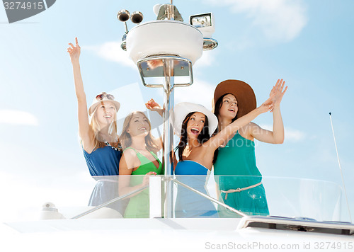 Image of girls waving on boat or yacht
