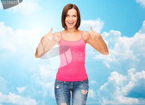 Image of woman in blank pink tank top pointing fingers