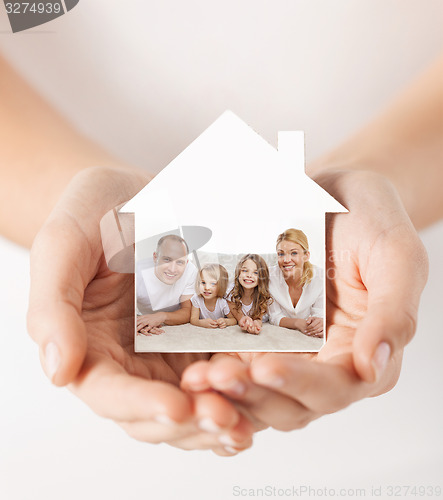 Image of close up of hands holding house shape with family