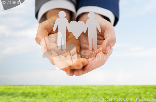 Image of close up of male gay couple with love symbol