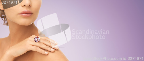 Image of close up of woman with cocktail ring on hand