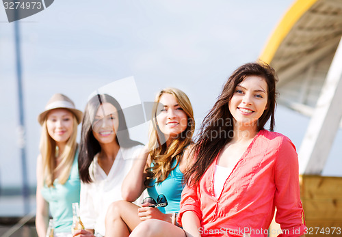 Image of girls with drinks on the beach