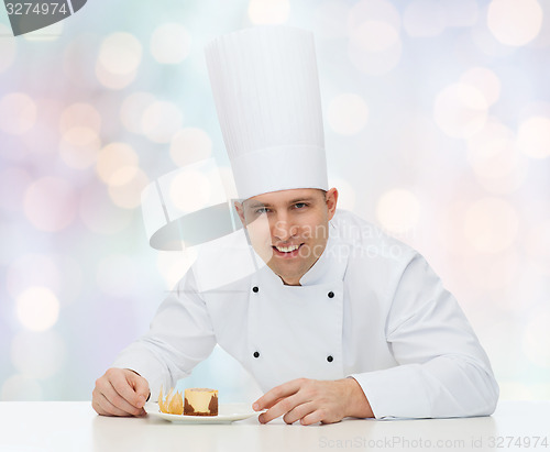 Image of happy male chef cook with dessert