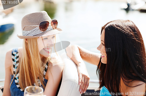 Image of girls with champagne glasses on boat