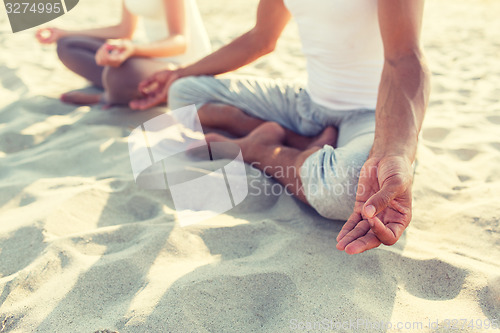 Image of close up of couple making yoga exercises outdoors