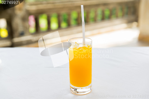 Image of glass of fresh orange fruit juice at restaurant