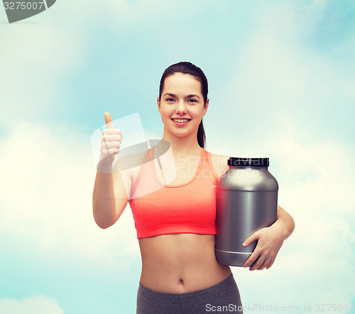 Image of teenage girl with jar of protein showing thumbs up