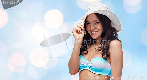 Image of happy young woman in bikini swimsuit and sun hat