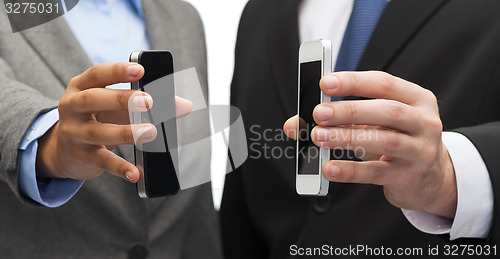 Image of businessman and businesswoman with smartphones