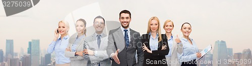 Image of group of smiling businessmen making handshake