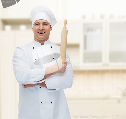 Image of happy male chef cook holding rolling pin