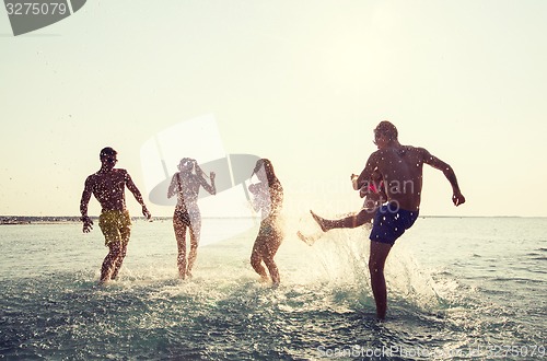 Image of happy friends having fun on summer beach