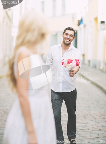 Image of couple with flowers in the city