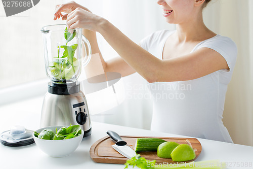 Image of close up of woman with blender and vegetables