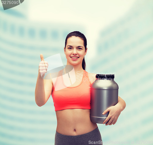 Image of teenage girl with jar of protein showing thumbs up