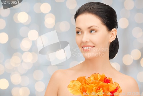 Image of beautiful young woman with flowers