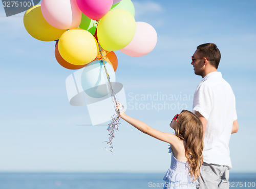 Image of father and daughter with colorful balloons