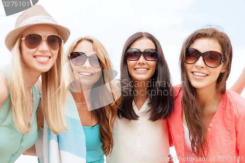 Image of girls in shades having fun on the beach