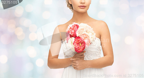 Image of bride or woman with bouquet of flowers