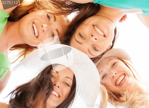 Image of faces of girls looking down and smiling